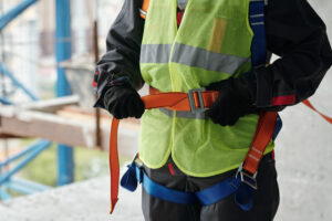 Builder in hardhat gloves and reflective vest