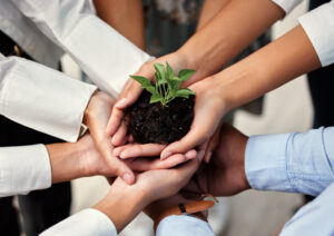 hands-holding-green-plant-of-technology-in-corporate-sustainability