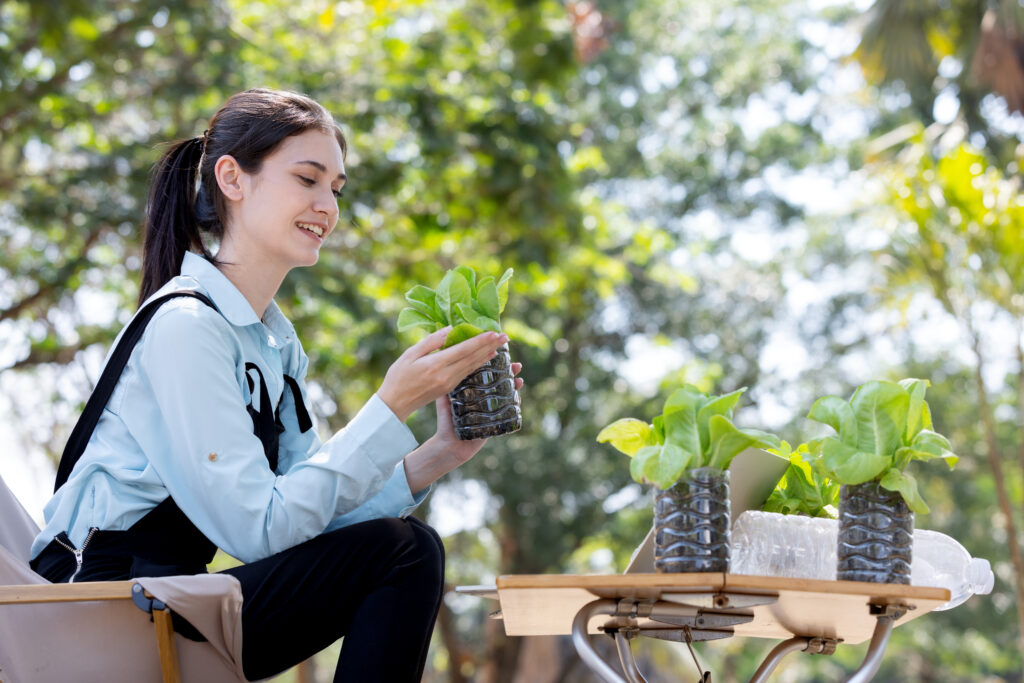 woman holding plant to learn sustainability and awareness